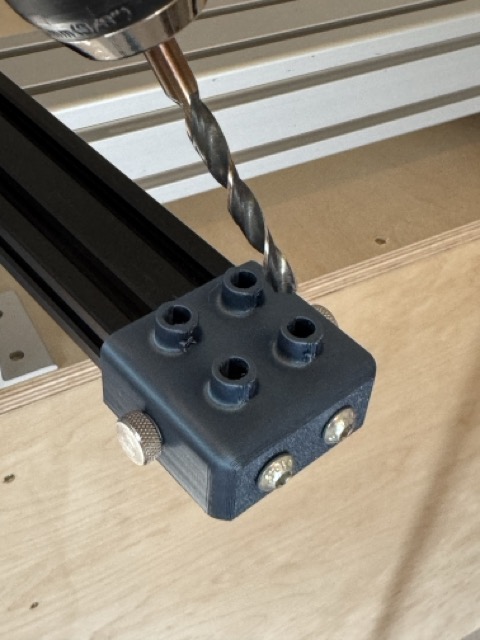 2040 extrusion drill guide positioned beneath a drill bit