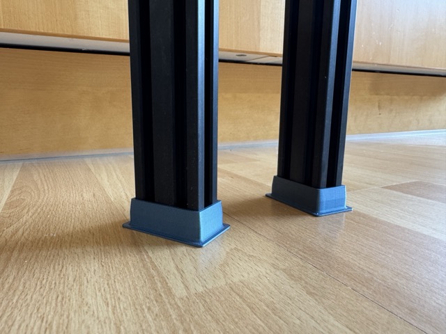3D-printed foot caps installed on vertical 2040 aluminum extrusions
