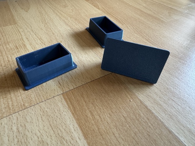 Three 3D-printed foot caps for 2040 aluminum extrusion
